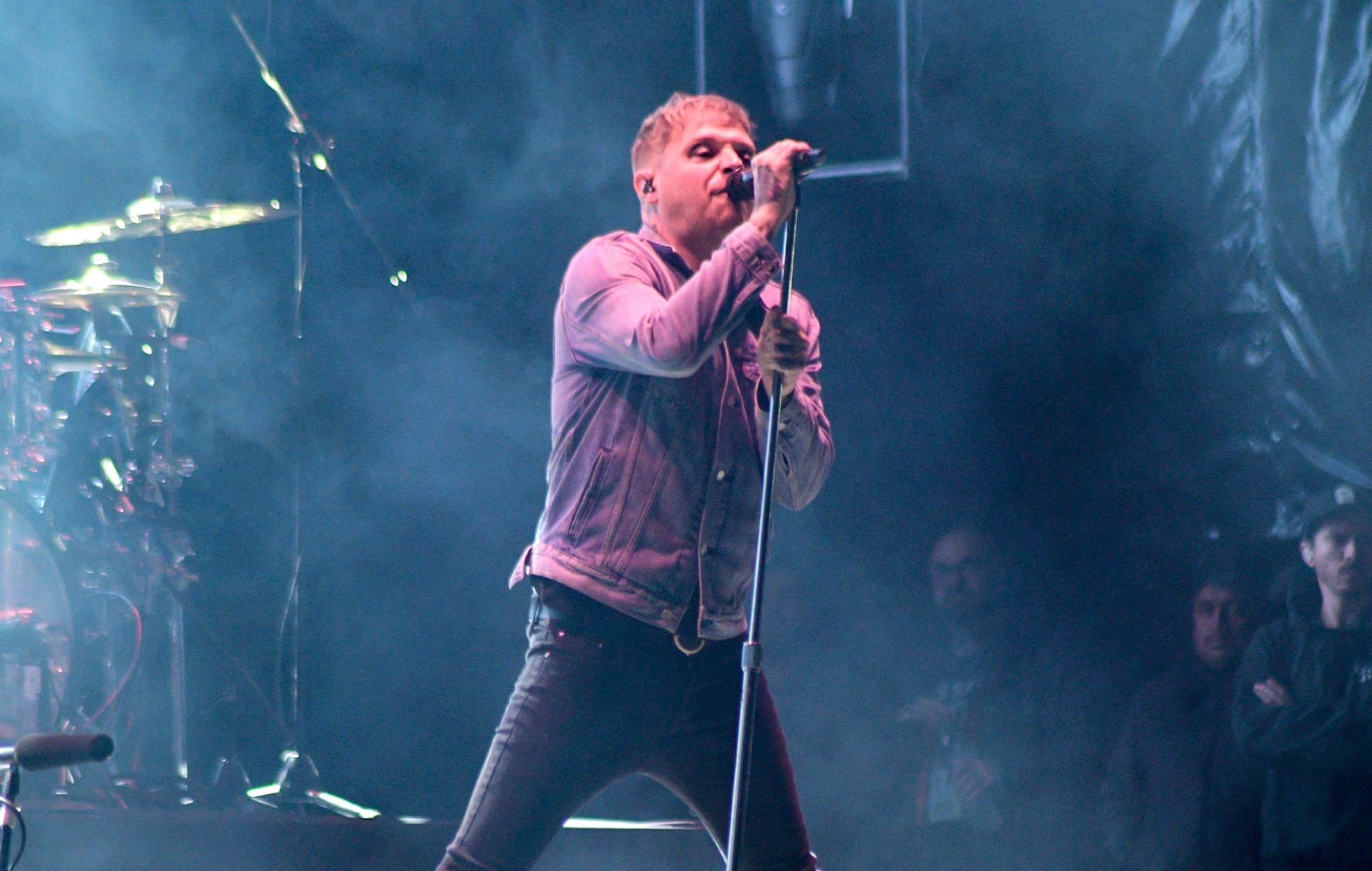 Sam Carter performing live on stage with Architects