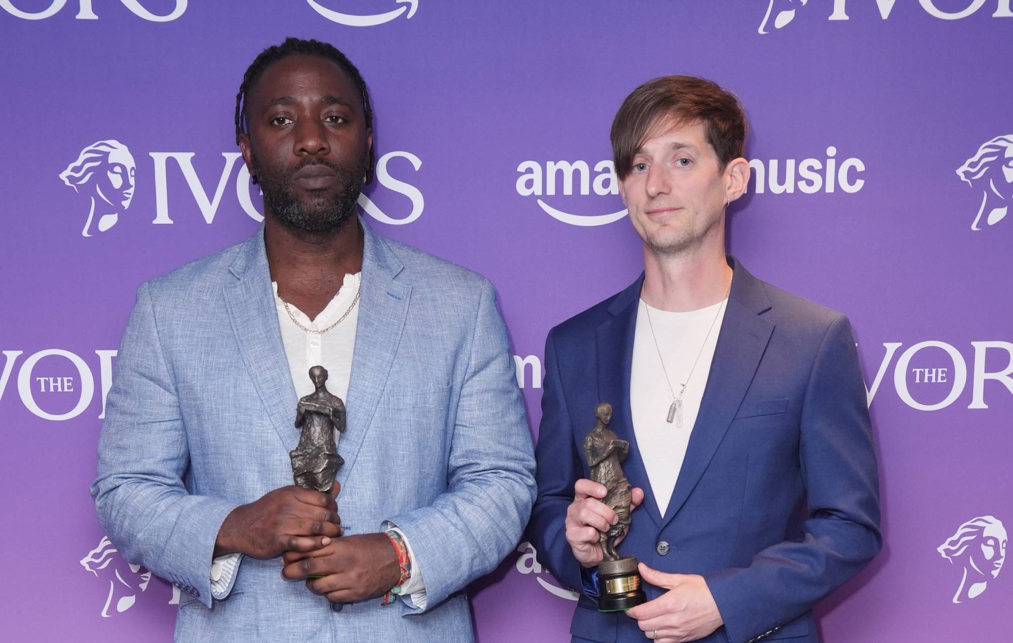 Kele Okereke and Russell Lissack from Bloc Party with their Outstanding Contribution awards pose in the winners' room during the Ivor Novello Awards (Photo by Ben Whitley/PA Images via Getty Images)