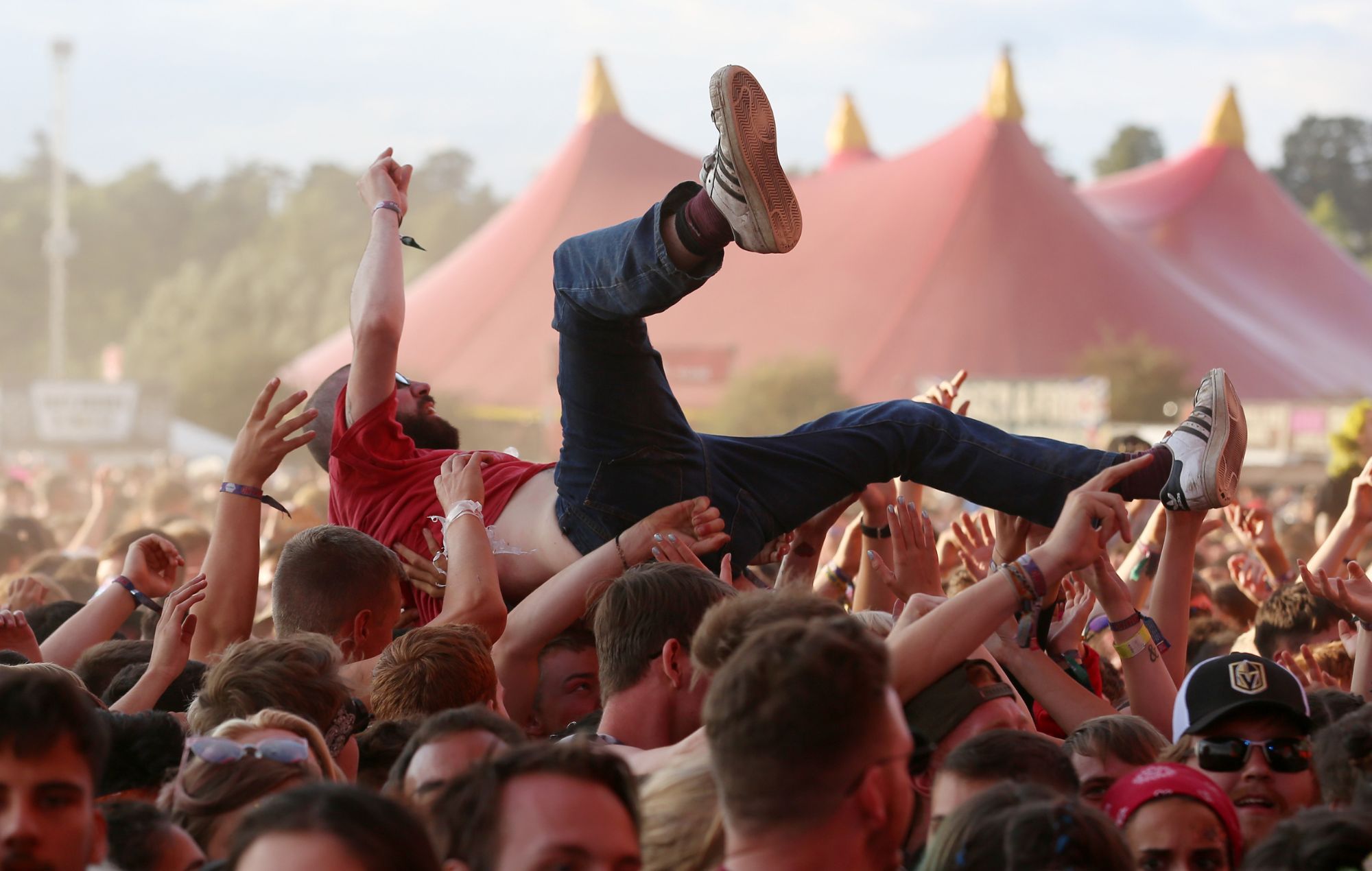 A music fan crowd surfs at Reading Festival