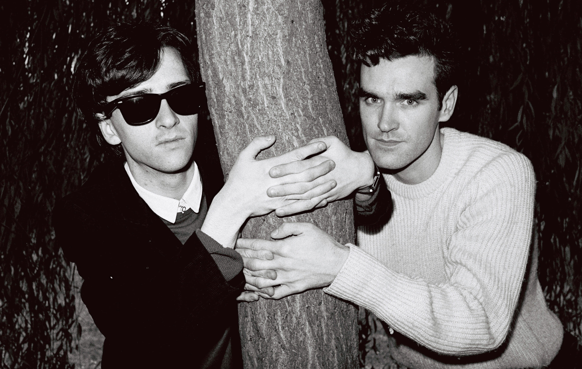 a black and white photograph of The Smiths' Johnny Marr (left) and Morrissey (right) pictured together in 1983