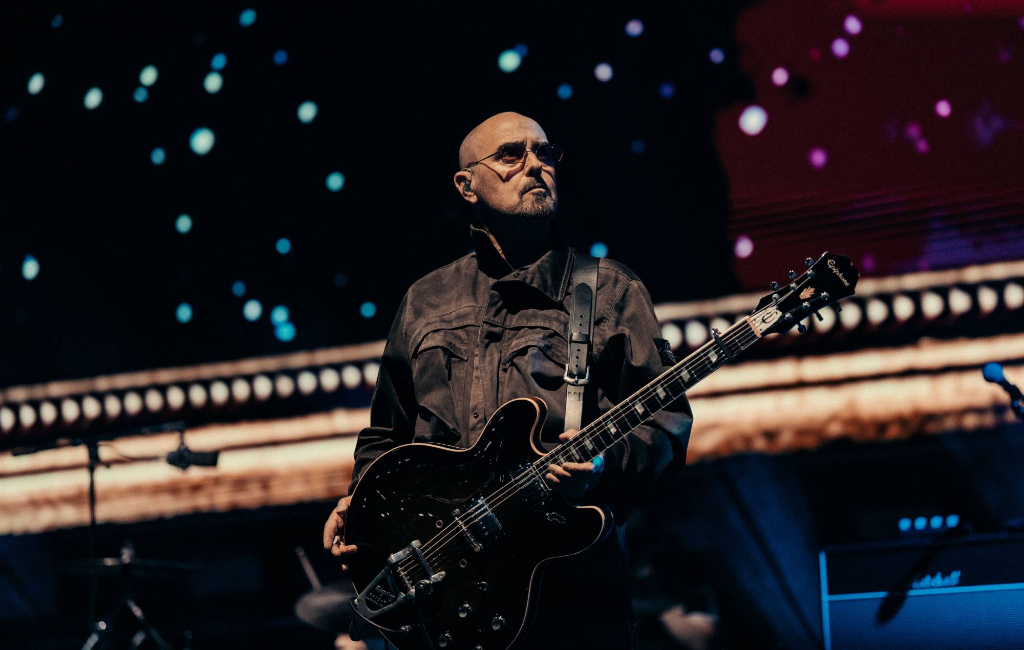 Bonehead on stage with Oasis at Wembley Stadium. Credit: Big Brother Recordings/Sharon Lopez