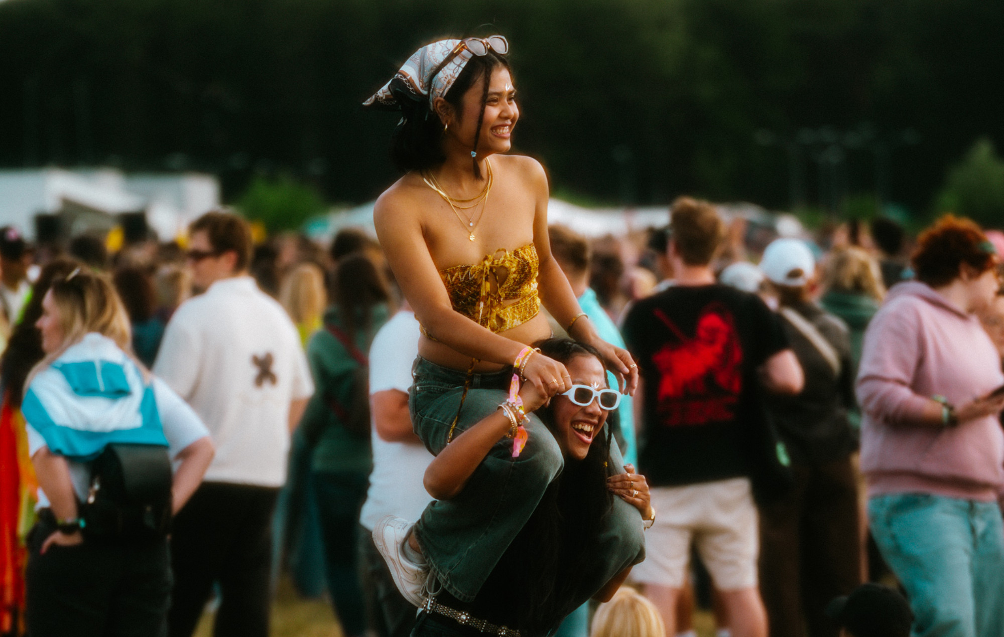 A woman giving another a piggyback at Open'er Festival 2025. Photo credit: STANISZEWSKA