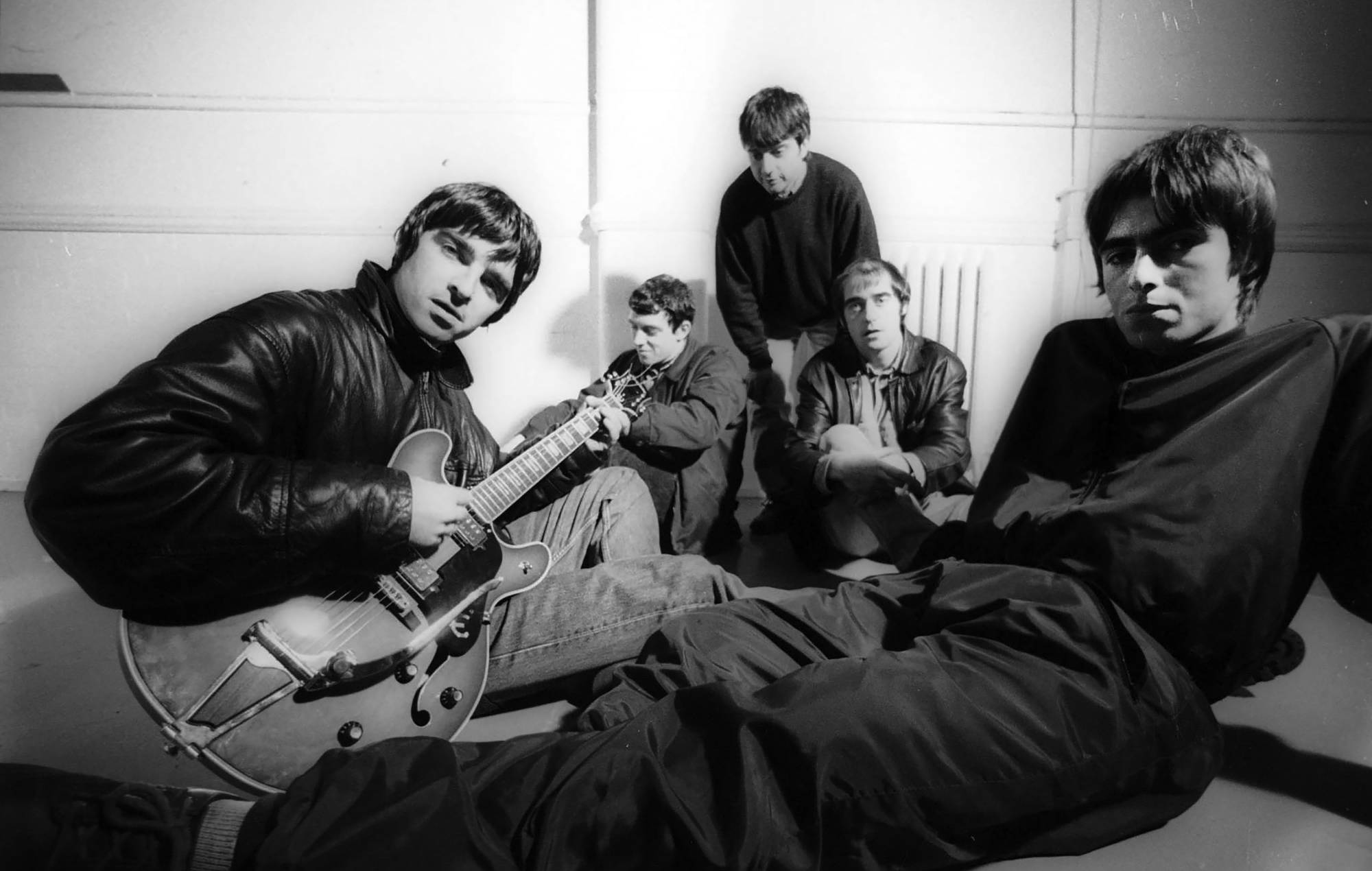 Group portrait of British rock band Oasis at Nomad Studios in Manchester, United Kingdom, 29th November 1993. L-R Noel Gallagher, Paul Arthurs (aka Bonehead), Paul McGuigan, Tony McCarroll,Liam Gallagher. (Photo by James Fry/Getty Images)