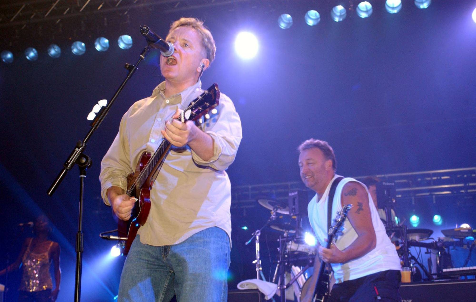 Bernard Sumner and Peter Hook of New Order performing on the 'Get Ready' tour in 2001 at London's Brixton Academy (Photo by Yui Mok - PA Images/PA Images via Getty Images)