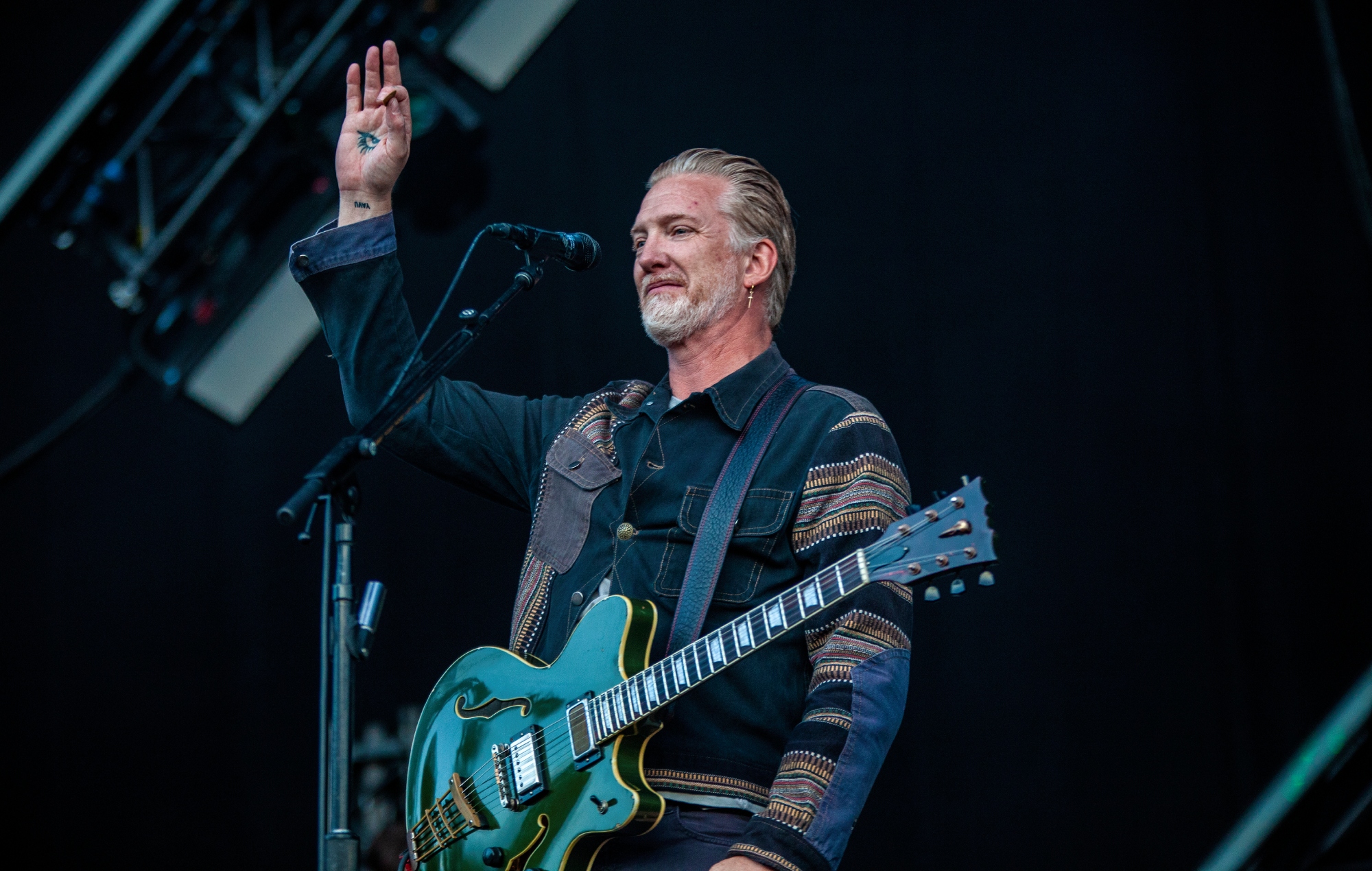 Josh Homme performing live on stage with Queens Of The Stone Age