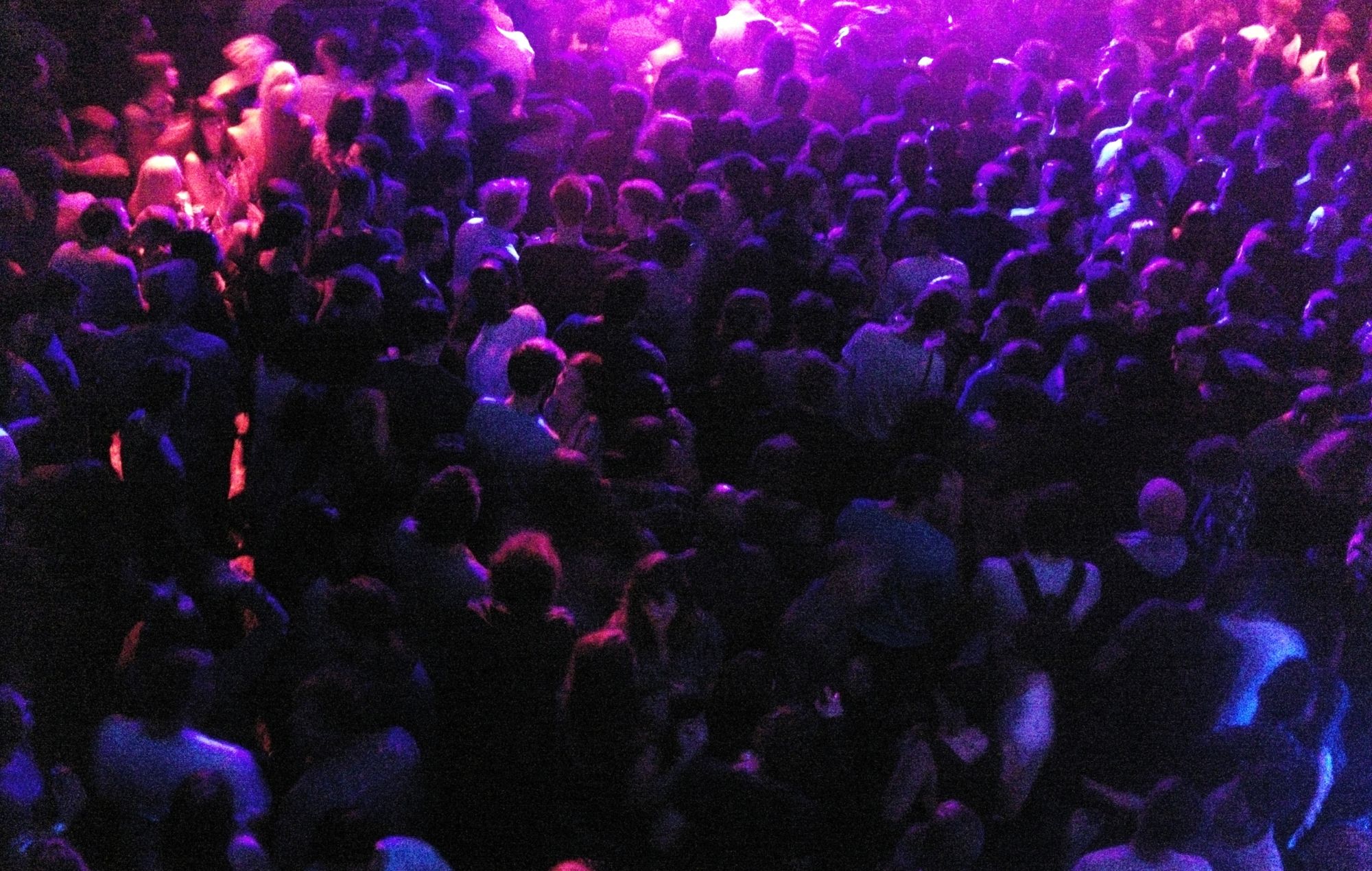 A large energetic crowd at a UK nightclub.