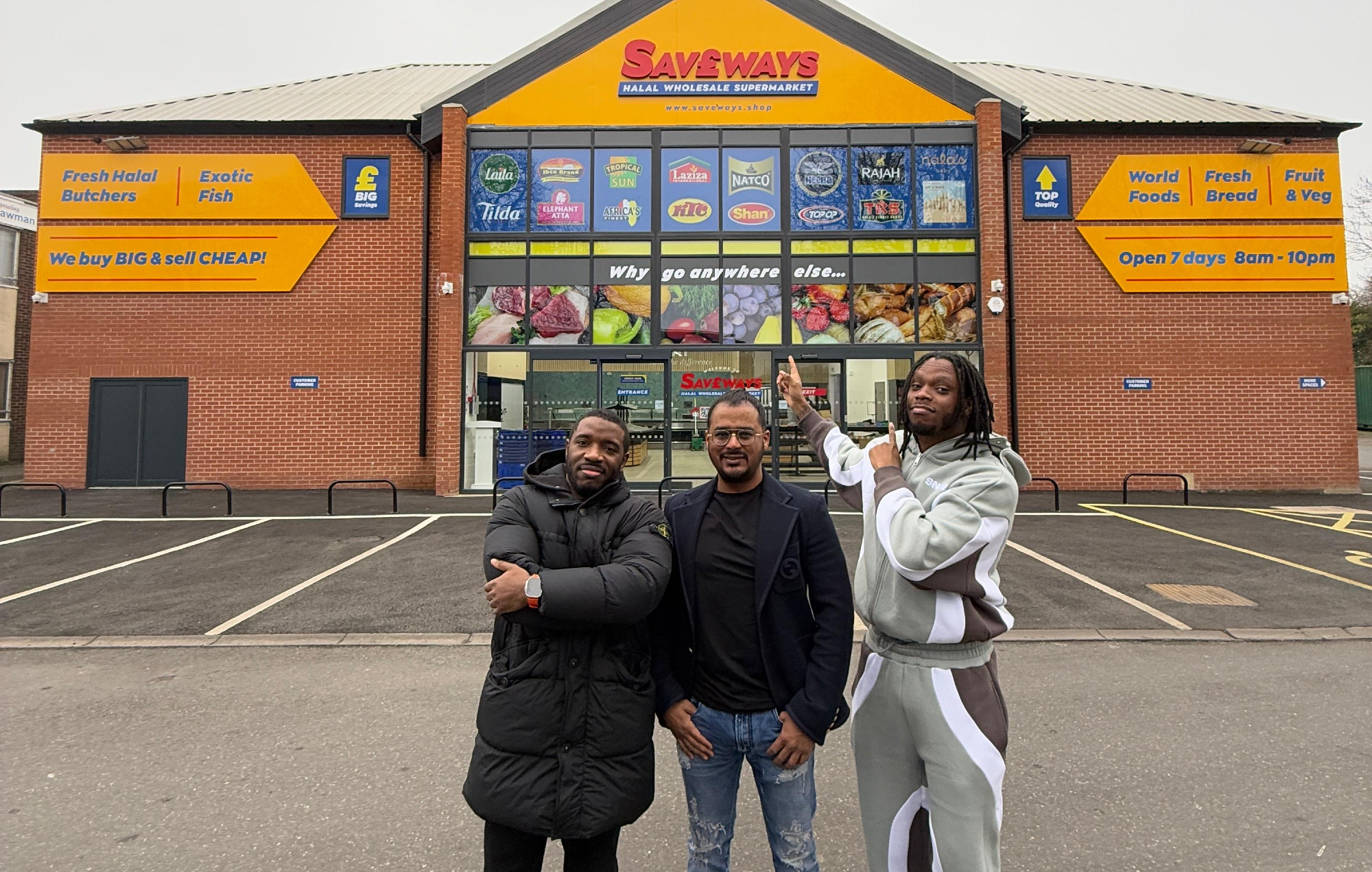 Krept and Konan with business partner Kaysor Ali in front of new supermarket, Saveways. Photo credit: press