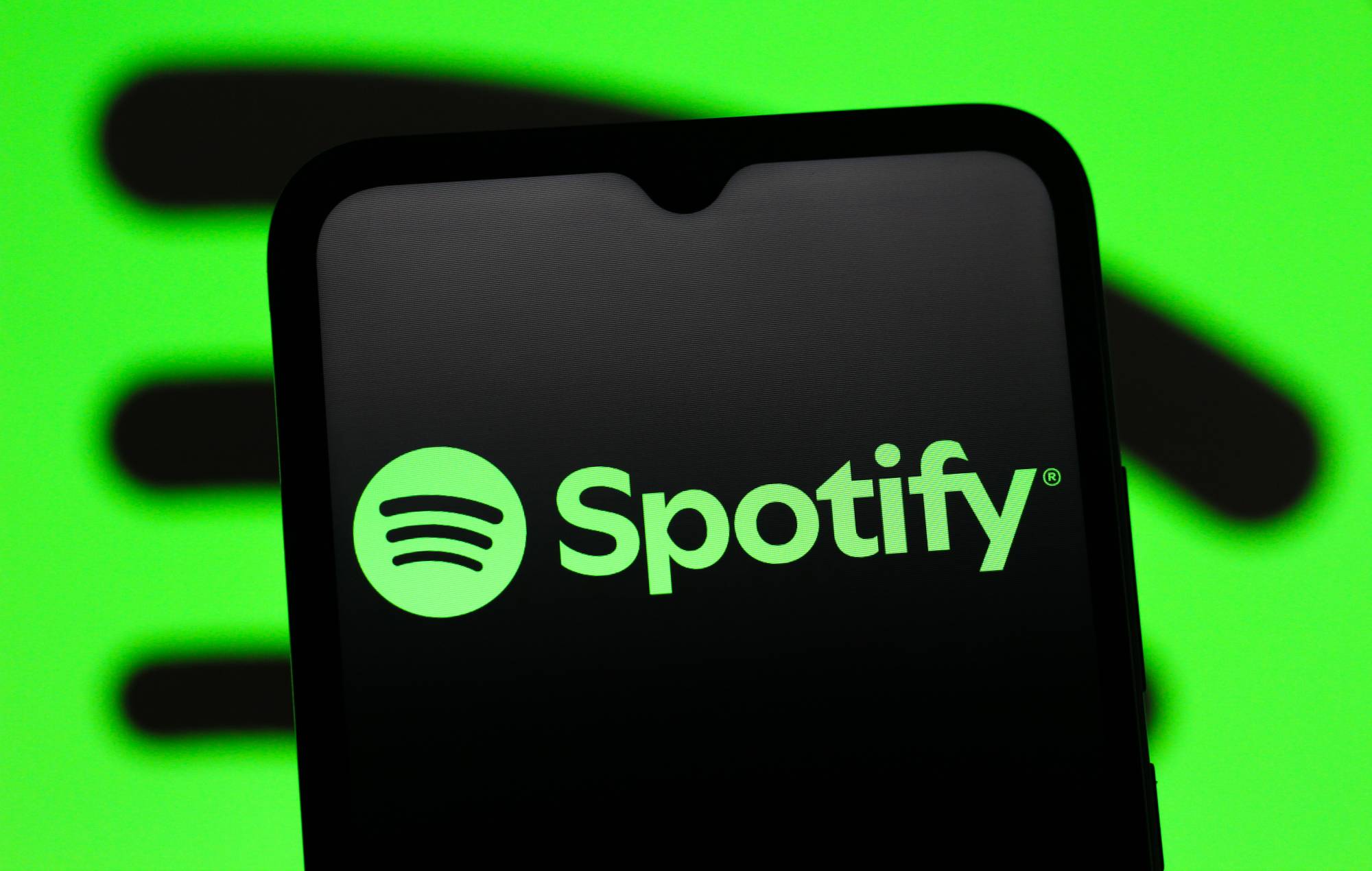 The Spotify logo is seen displayed on a smartphone screen. (Photo Illustration by Thomas Fuller/SOPA Images/LightRocket via Getty Images)